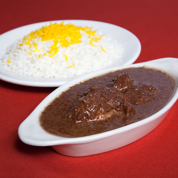 Farsi Cafe's Fesenjan, a rich Persian stew with chicken and walnuts, served with saffron rice.